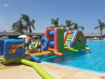 a group of people playing in the water at a pool at Hotel Puerto Bahía & Spa in El Puerto de Santa María