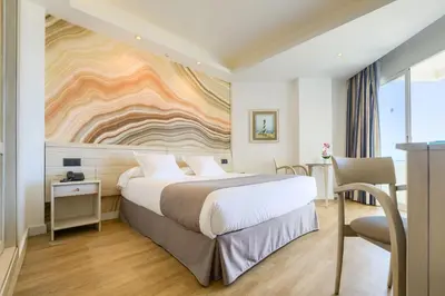 a hotel room with a bed and a desk at Hotel Puerto Bahía & Spa in El Puerto de Santa María