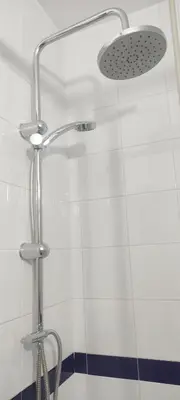 a shower with a glass door and a shower head at Hostal Restaurante La Giralda in Rota