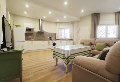 a living room with a couch and a table at APARTAMENTOS SANLUCAR CASA A in Sanlúcar de Barrameda