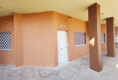 a empty room with a white door and orange walls at APARTAMENTOS SANLUCAR CASA B in Sanlúcar de Barrameda