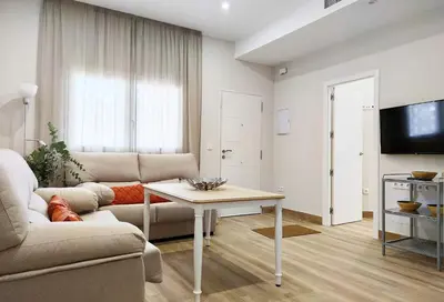 a living room with a couch and a table at APARTAMENTOS SANLUCAR CASA B in Sanlúcar de Barrameda