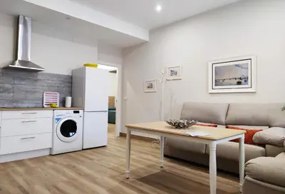 a living room with a couch and a table at APARTAMENTOS SANLUCAR CASA B in Sanlúcar de Barrameda