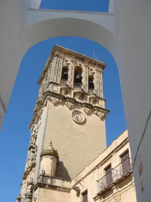 a tall tower with a clock on a building at Hotel El Convento in Arcos de la Frontera