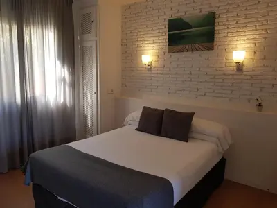 a bedroom with a bed with two pillows on it at Campomar Playa in El Puerto de Santa María