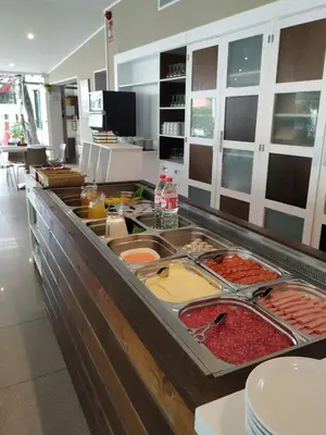 a buffet line with many different types of food at Campomar Playa in El Puerto de Santa María