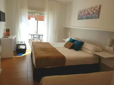 a bedroom with a large bed in a room at Campomar Playa in El Puerto de Santa María
