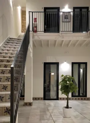 a staircase in a building with a potted plant at Apartamentos La Higuera by VGH in Jerez de la Frontera