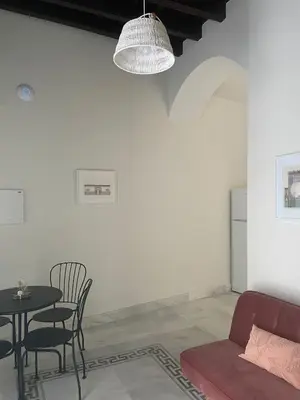 a living room with a table and a couch at Apartamentos La Higuera by VGH in Jerez de la Frontera