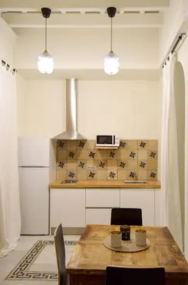 a kitchen with a wooden table and chairs at Apartamentos La Higuera by VGH in Jerez de la Frontera