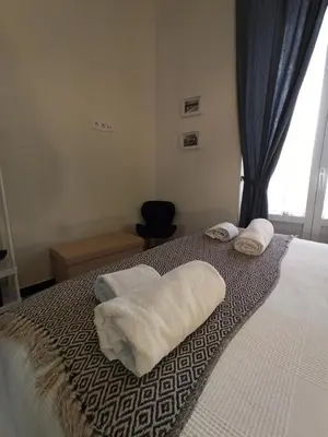 a bedroom with a bed with towels on it at Apartamentos La Higuera by VGH in Jerez de la Frontera