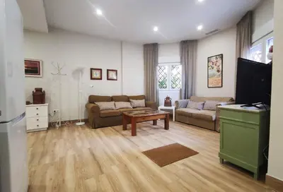 a living room with a couch and a table at APARTAMENTOS SANLUCAR CASA C in Sanlúcar de Barrameda