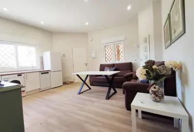 a living room with a couch and a table at APARTAMENTOS SANLUCAR CASA D in Sanlúcar de Barrameda