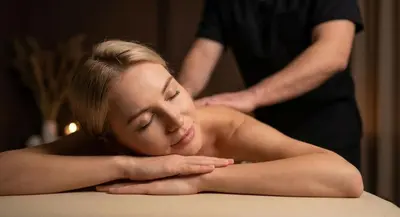 a woman getting a back massage from a man at Del Mar Hotel & Spa in El Puerto de Santa María