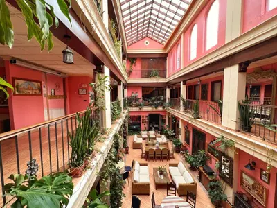 an indoor patio with tables and chairs in a building at Hotel Pinomar in El Puerto de Santa María