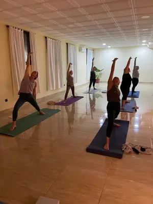 a group of people doing yoga in a room at Hotel Pinomar in El Puerto de Santa María