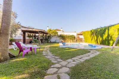 a backyard with a picnic table and a pool at Chalet El Santiscal in Arcos de la Frontera