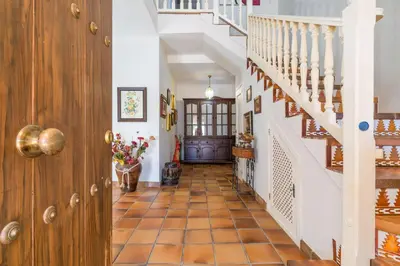 a hallway of a home with a staircase and a door at Chalet El Santiscal in Arcos de la Frontera