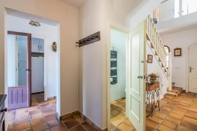 a hallway with doors and stairs in a house at Chalet El Santiscal in Arcos de la Frontera