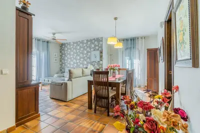 a living room with a couch and a table and chairs at Chalet El Santiscal in Arcos de la Frontera