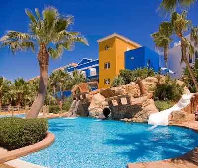 a resort pool with a slide and a water park at Playaballena in Costa Ballena