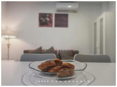 a glass bowl of pastries on a table at Ático en pleno centro de Jerez sin ascensor in Jerez de la Frontera