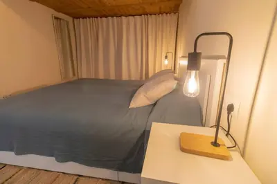 a bedroom with a bed and a lamp on a table at SH Casa de la Catedral. En el centro de la ciudad. in Cádiz