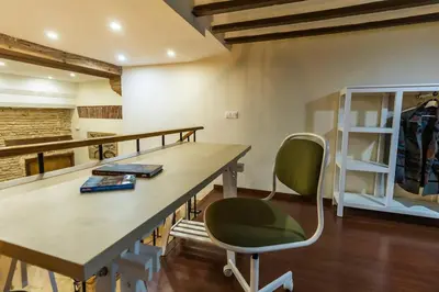 a room with a desk and two chairs and a shelf at SH Casa de la Catedral. En el centro de la ciudad. in Cádiz