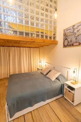 a bedroom with a large bed with two lamps and a window at SH Casa de la Catedral. En el centro de la ciudad. in Cádiz