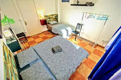 a room with a bedroom with a bed and a rug at Plaza Polvorista 4-Bedroom Apartment w Balcony in El Puerto de Santa María