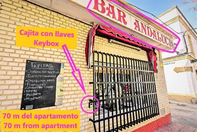 a restaurant with a gate on the side of a building at Plaza Polvorista 4-Bedroom Apartment w Balcony in El Puerto de Santa María