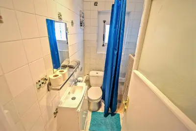 a small bathroom with a toilet and a sink at Plaza Polvorista 4-Bedroom Apartment w Balcony in El Puerto de Santa María