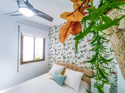 a bedroom with a bed and a plant at Vistahermosa Palm in El Puerto de Santa María