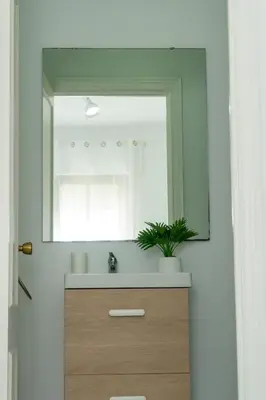 a bathroom with a sink and a mirror at Vistahermosa Palm in El Puerto de Santa María