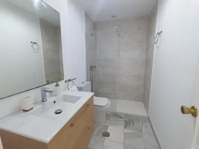 a bathroom with a sink and a toilet and a mirror at Vistahermosa Palm in El Puerto de Santa María