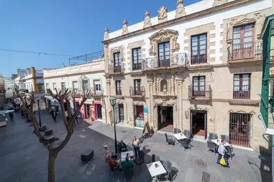 a group of people standing in front of a building at Casa Palacio de los Leones in El Puerto de Santa María