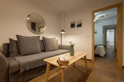 a living room with a couch and a table at Casa Palacio de los Leones in El Puerto de Santa María