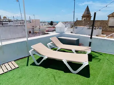 two chairs sitting on the roof of a building at Ático Cádiz 360 in Cádiz