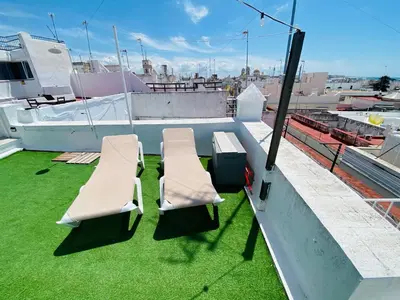two chairs and a table on top of a roof at Ático Cádiz 360 in Cádiz