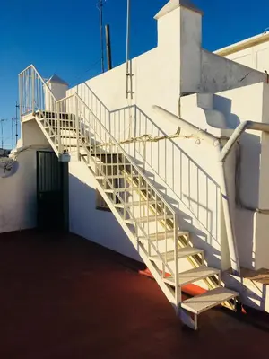 a staircase on the side of a white building at Ático Cádiz 360 in Cádiz