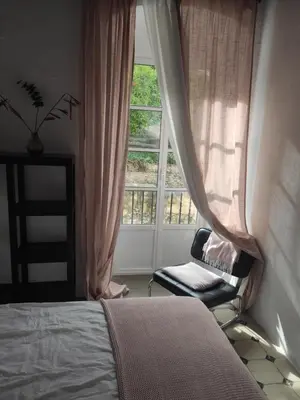 a bedroom with a bed and a window and a chair at Calle Nueva in Arcos de la Frontera
