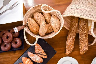 a table topped with a basket of bagels and donuts at The Place Bodega Real by ALEGRIA in El Puerto de Santa María