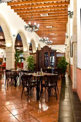 a dining room with tables and chairs in a building at The Place Bodega Real by ALEGRIA in El Puerto de Santa María