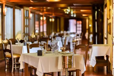 a restaurant with tables and chairs with white table cloth at The Place Bodega Real by ALEGRIA in El Puerto de Santa María
