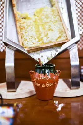 a table with a picture and a vase on a table at The Place Bodega Real by ALEGRIA in El Puerto de Santa María