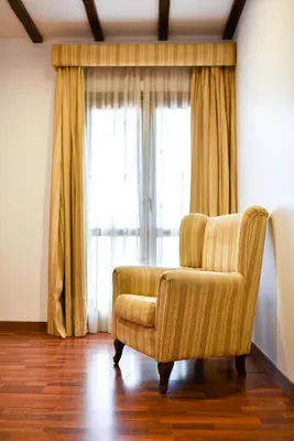 a chair in a room with a large window at The Place Bodega Real by ALEGRIA in El Puerto de Santa María