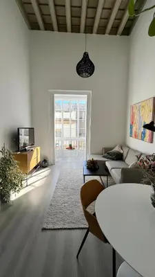 a living room with a couch and a table at Apartamento Duplex casa Palacio rehabilitado centro El Puerto in El Puerto de Santa María