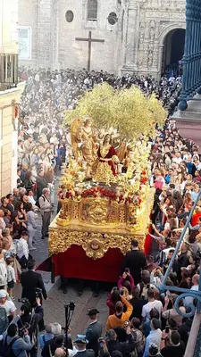 a large crowd of people watching a large float in a church at Apartamento Duplex casa Palacio rehabilitado centro El Puerto in El Puerto de Santa María