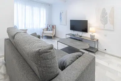 a living room with a couch and a tv at Apartamento El parador del boticario in Cádiz