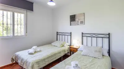 two beds in a room with white walls and windows at Chalet Algar by Ruralidays in Algar